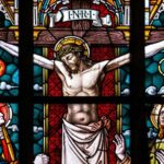Stained glass image of Jesus Christ hanging on cross