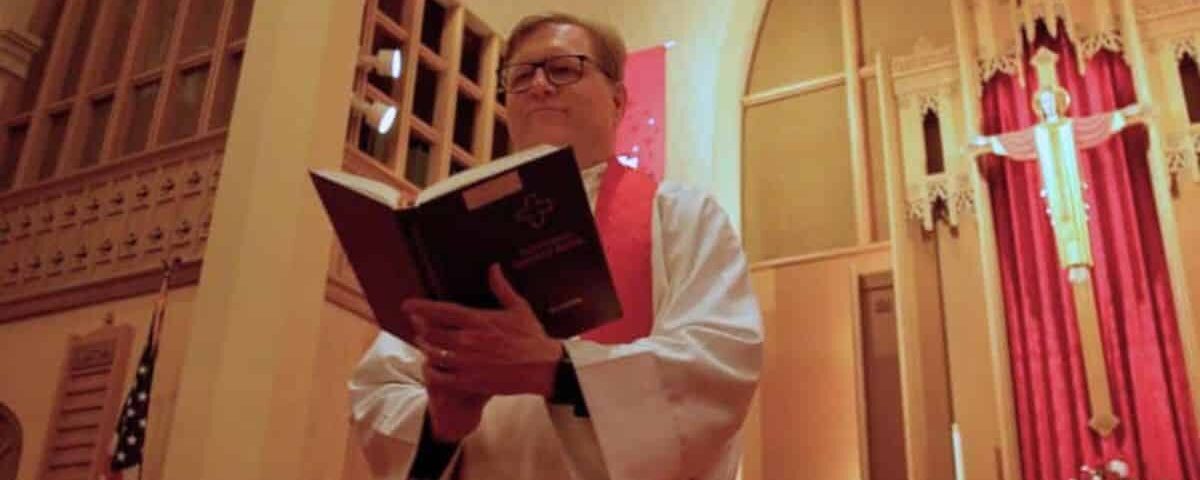 Pastor Joe Glombicki holding Lutheran Service Book at Bethlehem Lutheran Church in West Dundee, IL