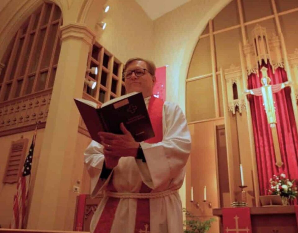 Pastor Joe Glombicki holding Lutheran Service Book at Bethlehem Lutheran Church in West Dundee, IL