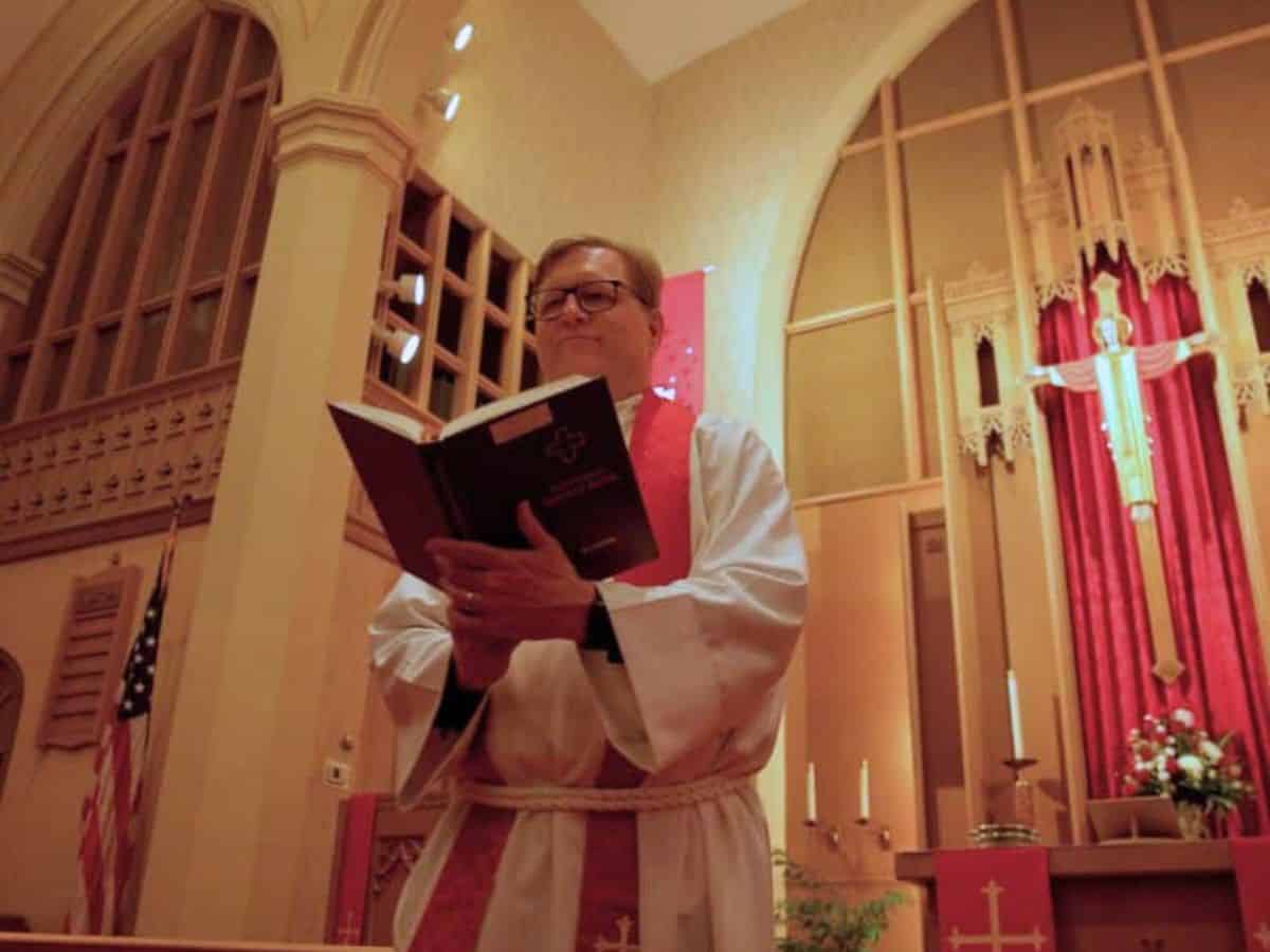 Pastor Joe Glombicki holding Lutheran Service Book at Bethlehem Lutheran Church in West Dundee, IL