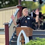 Pastor Joe Glombicki preaching outside at park at Bethlehem Lutheran Church in West Dundee, IL
