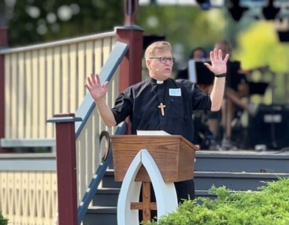 Pastor Joe Glombicki preaching outside at park at Bethlehem Lutheran Church in West Dundee, IL