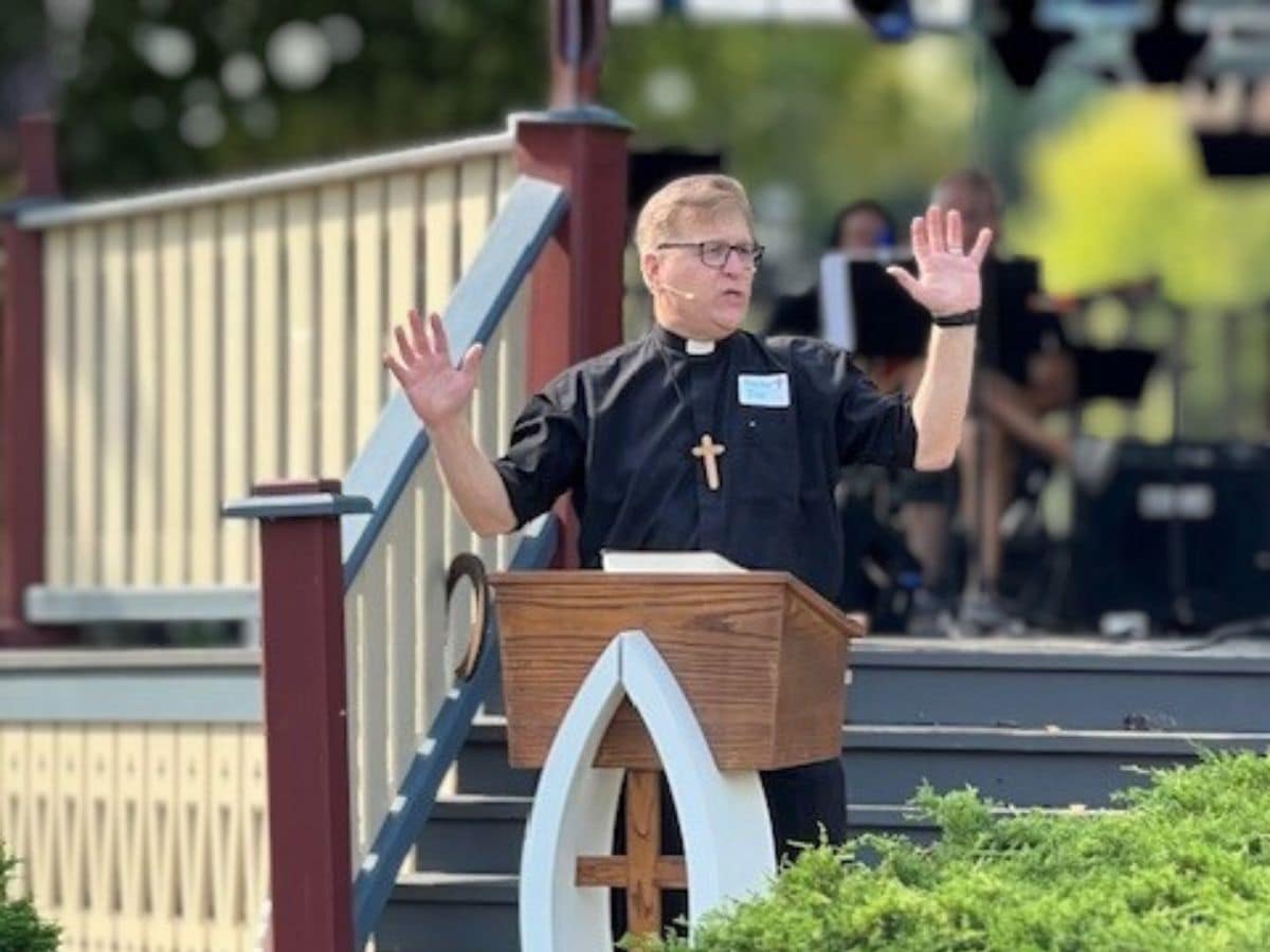 Pastor Joe Glombicki preaching outside at park at Bethlehem Lutheran Church in West Dundee, IL